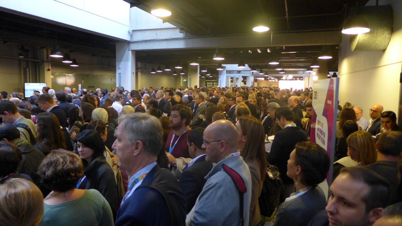 Large crowd of delegates wait patiently to enter ESMO16 Presidential Symposium